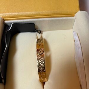 FENDI gold bracelet fit is a size small. The item is gently used.